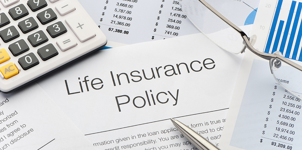 Close up of Life Insurance Policy with pen, calculator